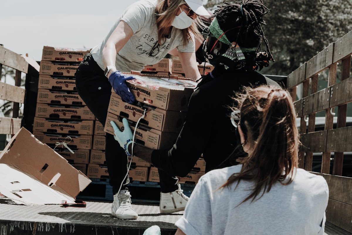 Volunteers loading donation boxes, representing HEARD's community outreach